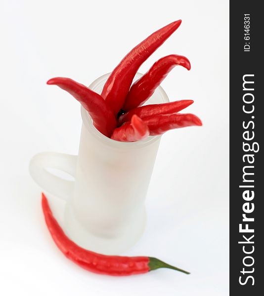 Red peppers in a frosted glass isolated. Red peppers in a frosted glass isolated
