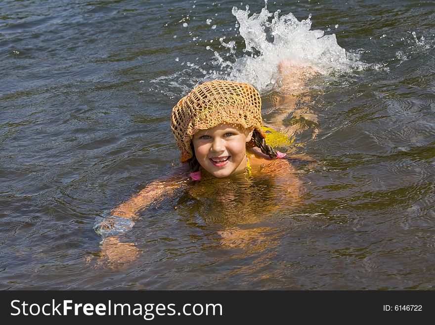 Little girl swimming in a river in the summer. Little girl swimming in a river in the summer