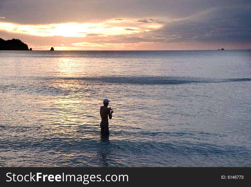 Reeling in the Surf at Sunset