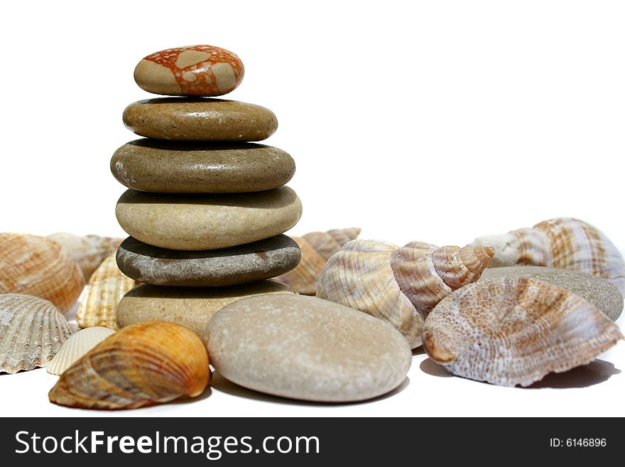 An image of a little stone tower with shells. An image of a little stone tower with shells