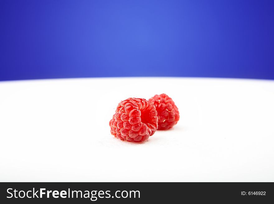 The fresh raspberry lays on a white background. The fresh raspberry lays on a white background