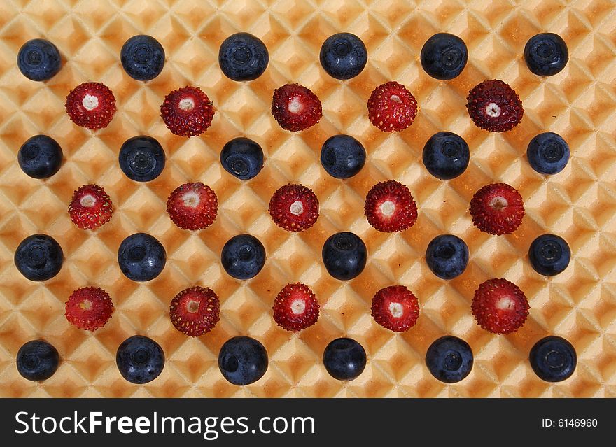 Forest fruits on wafer as background