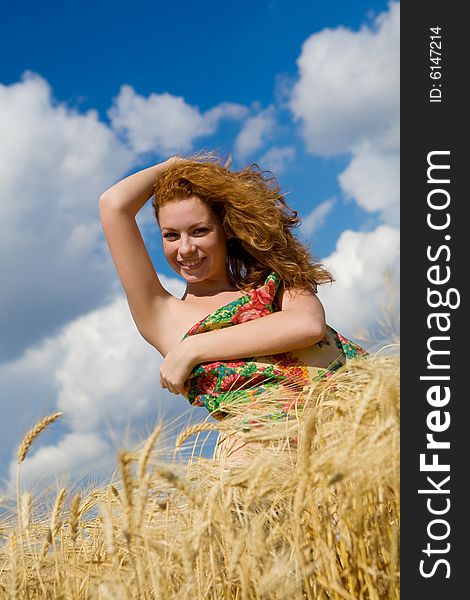 Beautiful caucasian model in golden wheat field