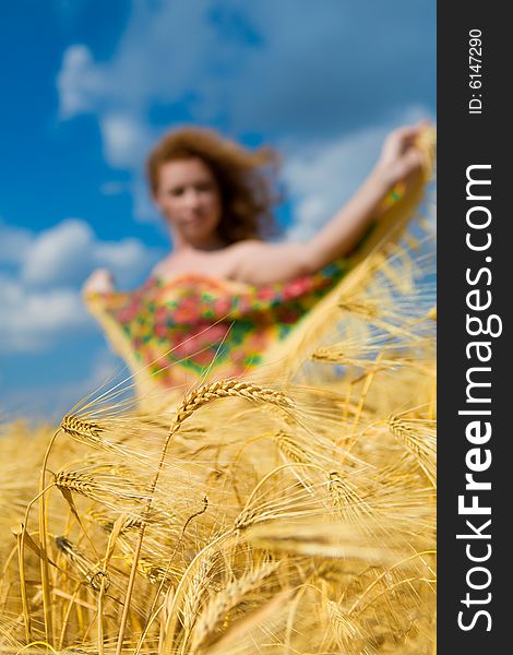 Beautiful caucasian model in golden wheat field