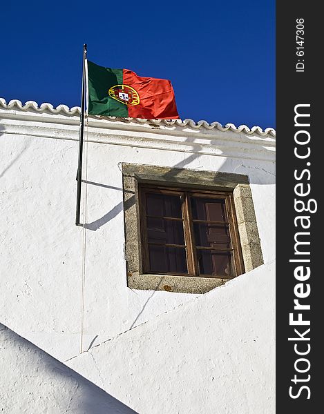 Portuguese flag hoisted in the former Court House of the medieval village of Monsaraz, Alentejo, Portugal. Portuguese flag hoisted in the former Court House of the medieval village of Monsaraz, Alentejo, Portugal