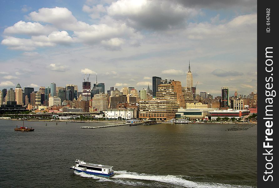 The view of ferry boat and Manhattan skyline in a background (New York City). The view of ferry boat and Manhattan skyline in a background (New York City).