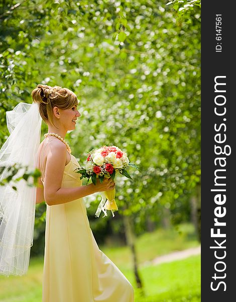 Young beautiful bride with flowers outdoor