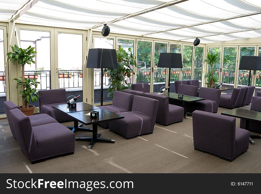 Brightly lit restaurant interior with gray chairs