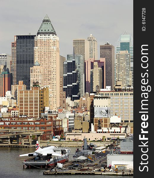 The view of the plane on a boat and Manhattan skyscrapers in a background (New York City).