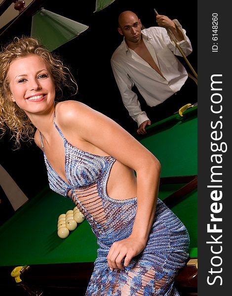 Model sitting on green snooker table