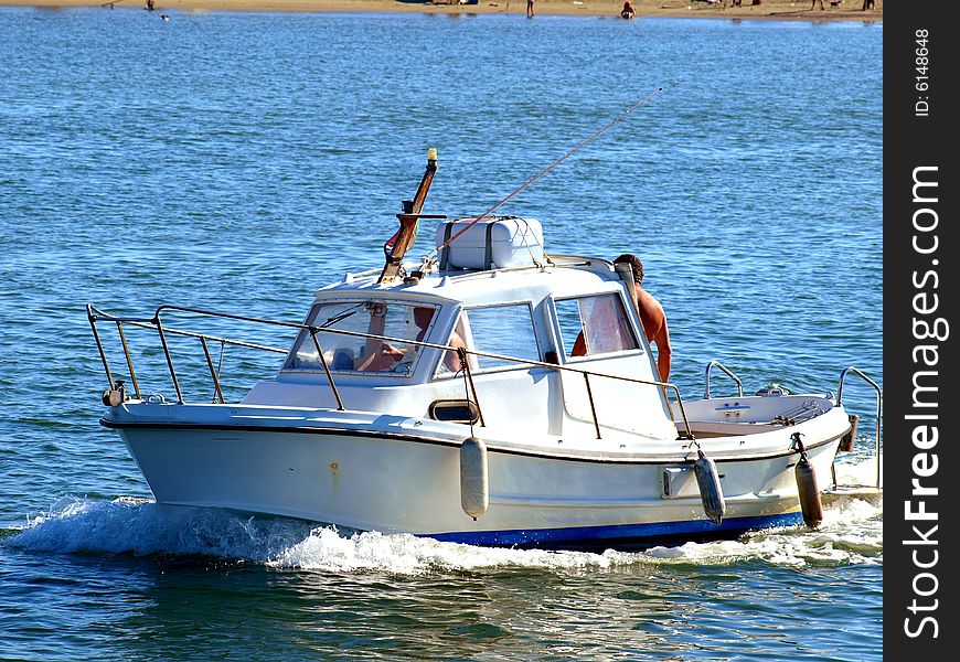 A good shot of a little boat arriving in the port. A good shot of a little boat arriving in the port