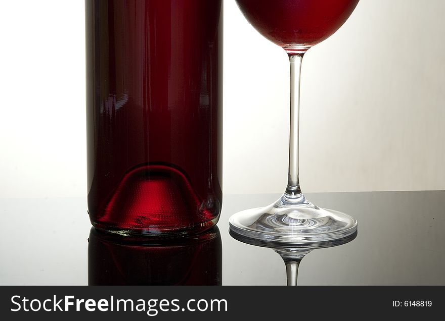A wine bottle and a glass. A wine bottle and a glass