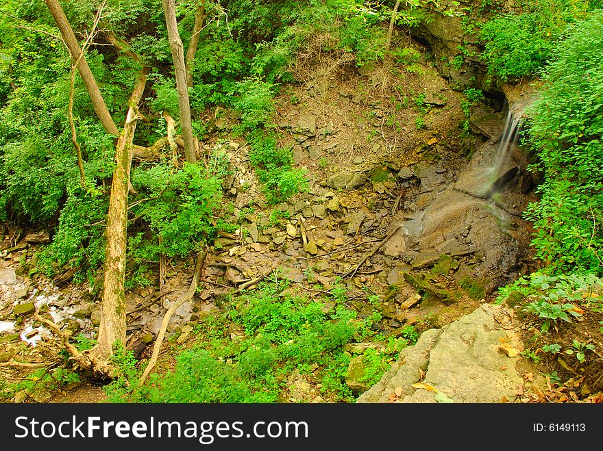 This is a bird eyes view of an open area near a small waterfall. This is a bird eyes view of an open area near a small waterfall.