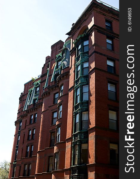 Old boston brownstone showing curves, angles,ornate window frmaing and slate roofs