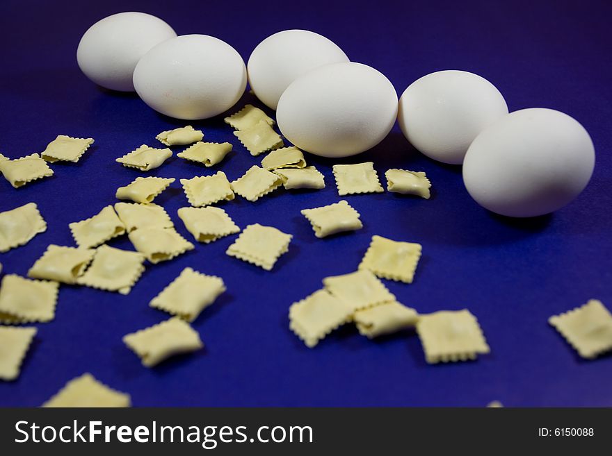 Eggs and pasta over blue background