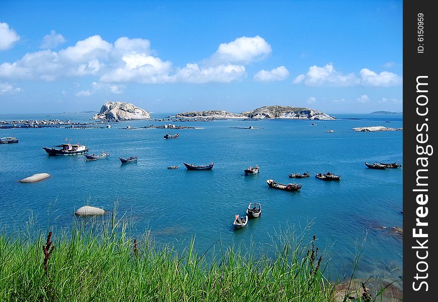 Under blue color sky and many boats on sea. Under blue color sky and many boats on sea