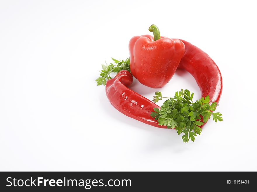Red peppers with parsley isolated on white