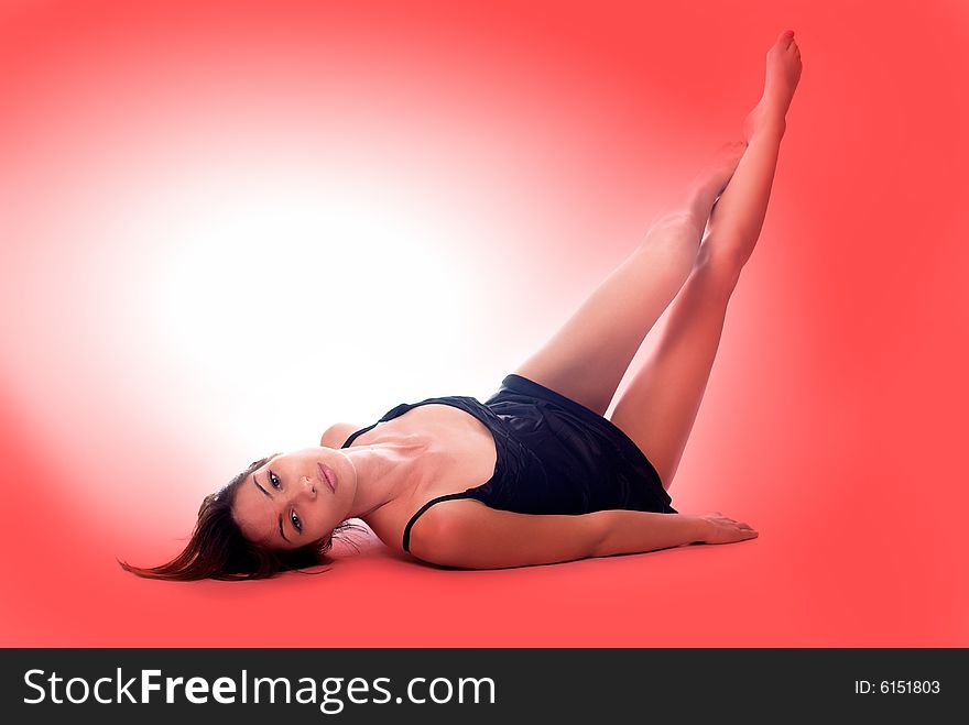 Young sexy girl posing on red backgrounds, with legs up. Young sexy girl posing on red backgrounds, with legs up
