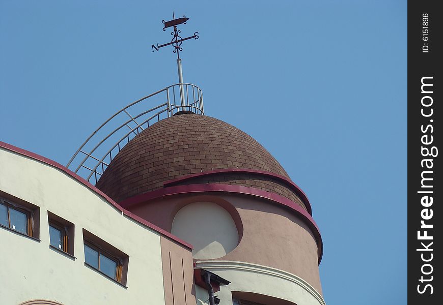 Modern city building. Dome-shaped roof. Weather vane on a roof. Modern city building. Dome-shaped roof. Weather vane on a roof.