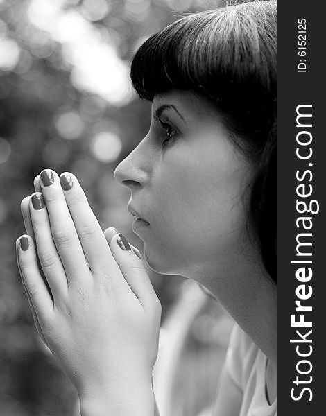 Black & white portrait of praying girl