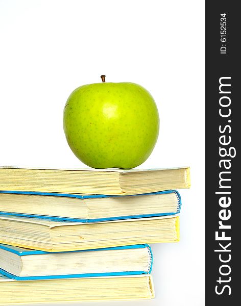 Green apple and stack of books for school