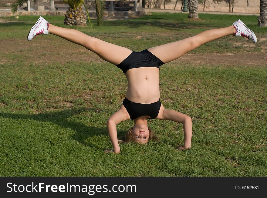 The Young girl exercising in the park