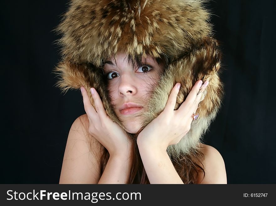 Portrait of the girl in a fur cap. Portrait of the girl in a fur cap.