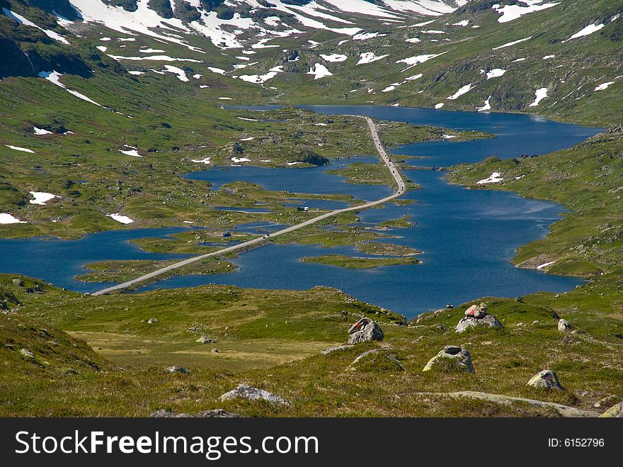 Top view of beautiful mountain road across the lake in Norway