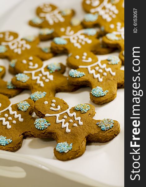 Closeup of fresh baked cheerful gingerbread men cookies with decorations