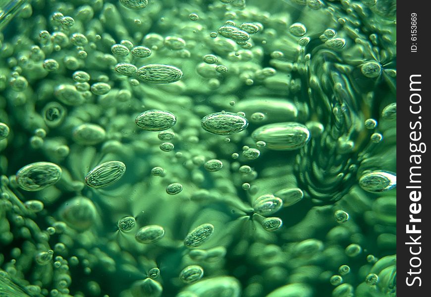 Set of green bubbles on a dark background
