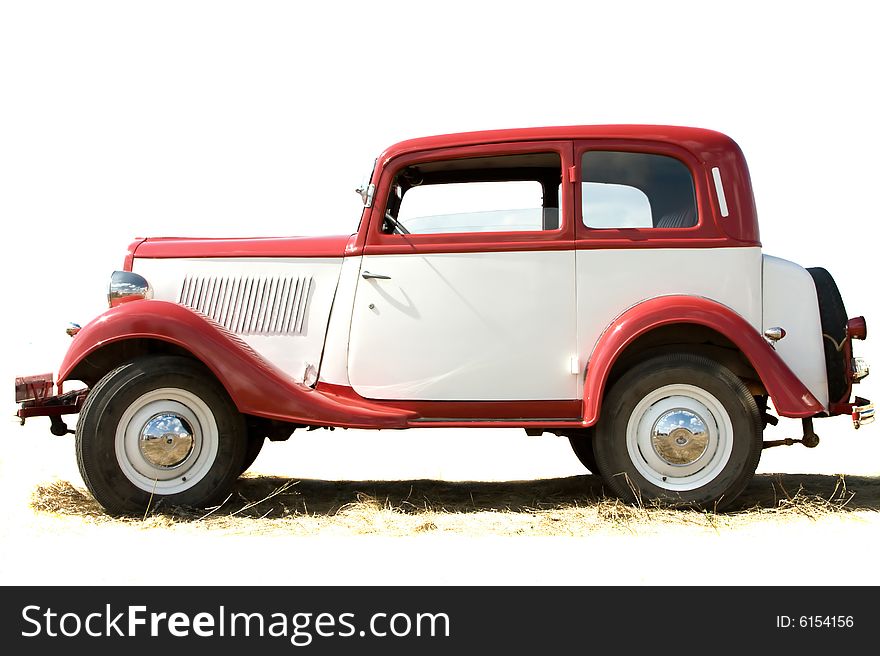 The old vintage car of white and red color. The old vintage car of white and red color