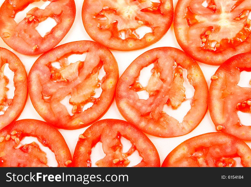 Background from thin slices a tomato of red color. Background from thin slices a tomato of red color.