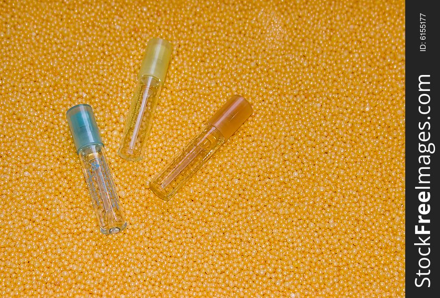 The image of three bottles lying on a yellow background