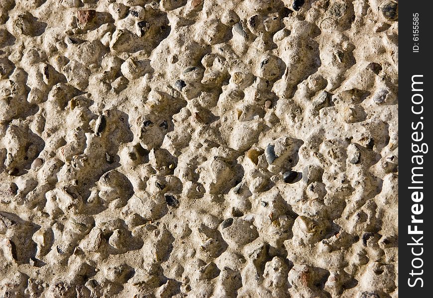 The image of the stones which are sticking out from concrete. The image of the stones which are sticking out from concrete