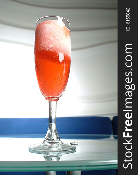 A red cocktail frappe in a bar Cristal table