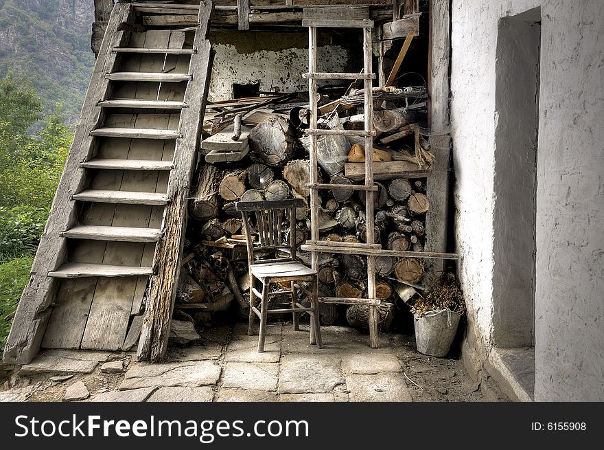 A chair beside stairs in front of an old bulgarian house. A chair beside stairs in front of an old bulgarian house