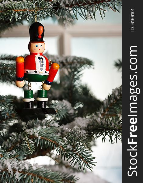 Christmas toy solider on tree near an old fashioned window