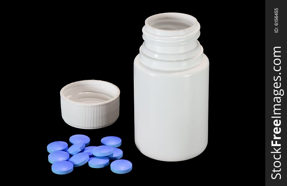 Small while plastic bottle with its cap off and pile of blue pills. Small while plastic bottle with its cap off and pile of blue pills