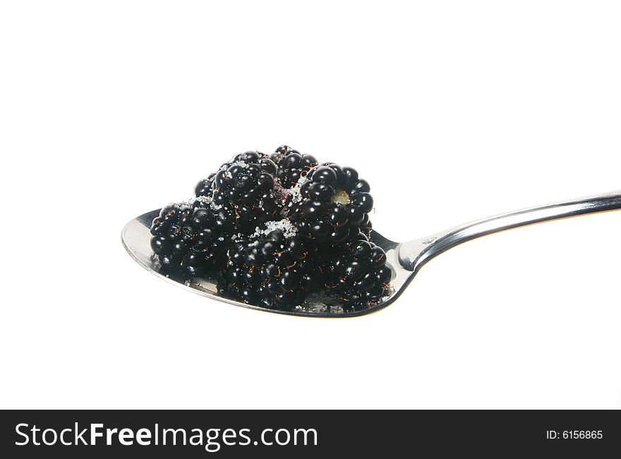 Sugared blackberries on a spoon isolated on white. Sugared blackberries on a spoon isolated on white