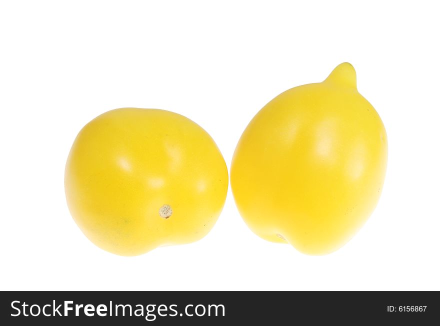 Two yellow tomatoes isolated on white