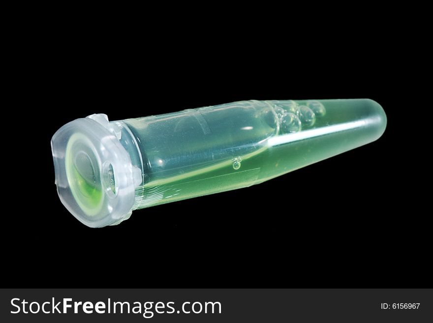 Eppendorf vial with green liquid isolated on black background