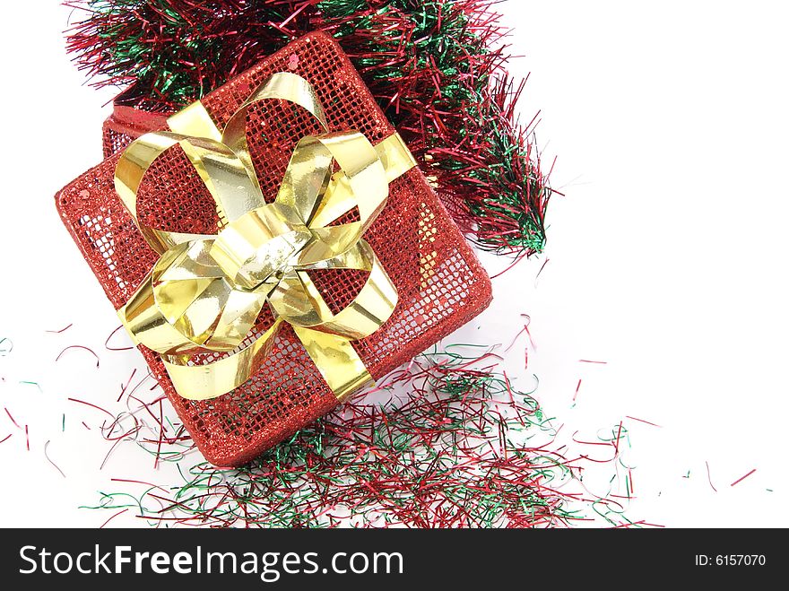 Red metal Christmas box with red and green garland inside.