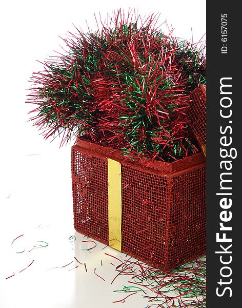 Red metal Christmas basket with red and green garland inside.