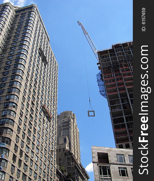 The view of skyscraper construction in Manhattan, New York City. The view of skyscraper construction in Manhattan, New York City.