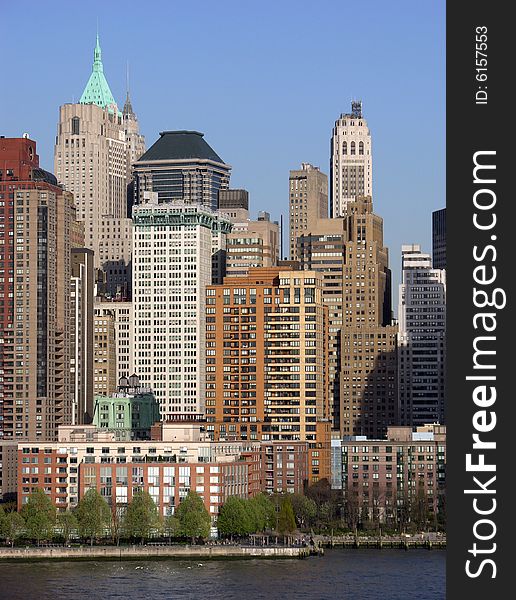 The view of different style skyscrapers of old Manhattan in evening light (New York City). The view of different style skyscrapers of old Manhattan in evening light (New York City).