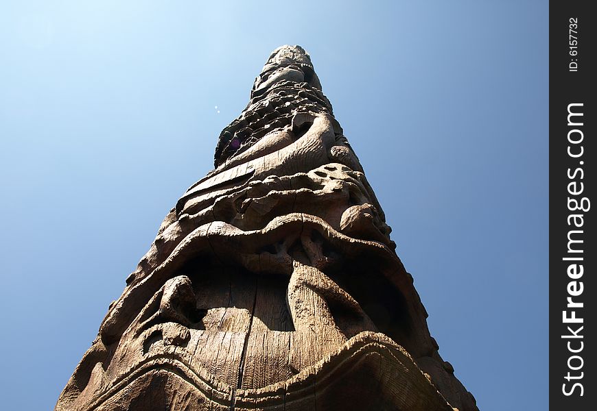 Looking up at a carved wooden Native American totem pole. Looking up at a carved wooden Native American totem pole.