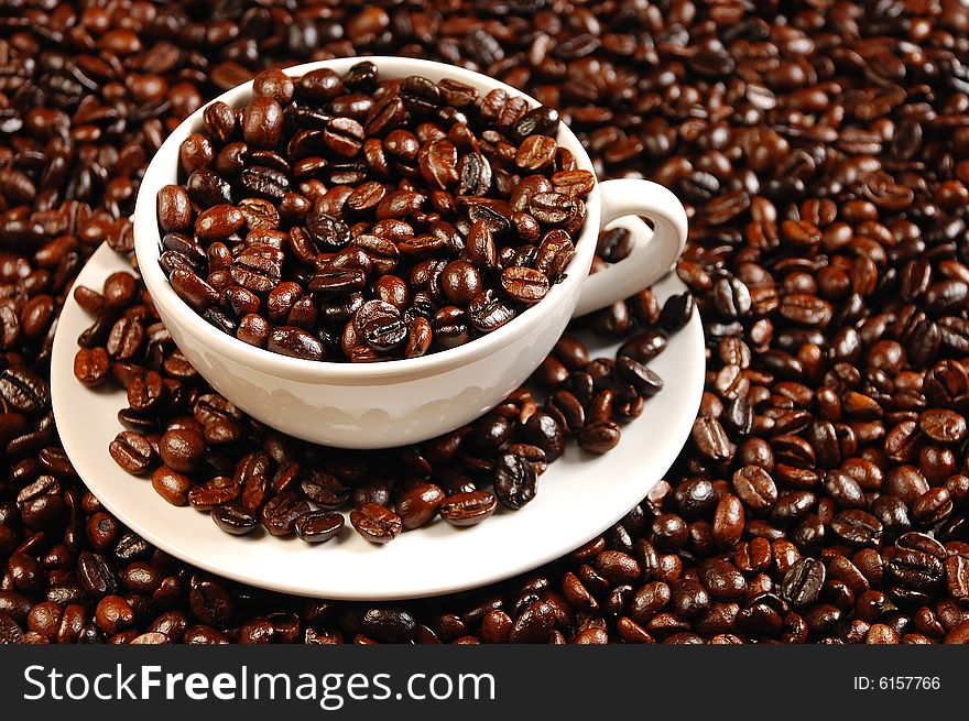 White cup and saucer with coffee beans. White cup and saucer with coffee beans