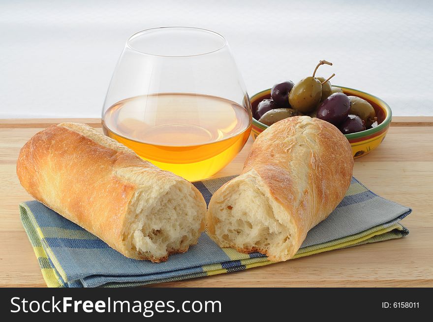 Freshly baked bread with olives and wine. Freshly baked bread with olives and wine.