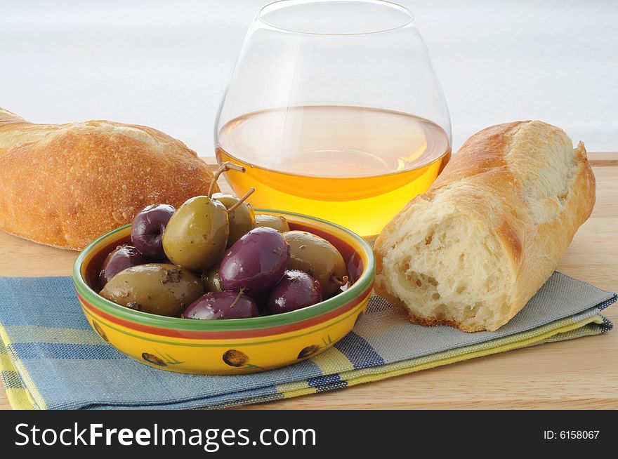 Dish of black and green olives with fresh bread. Dish of black and green olives with fresh bread.
