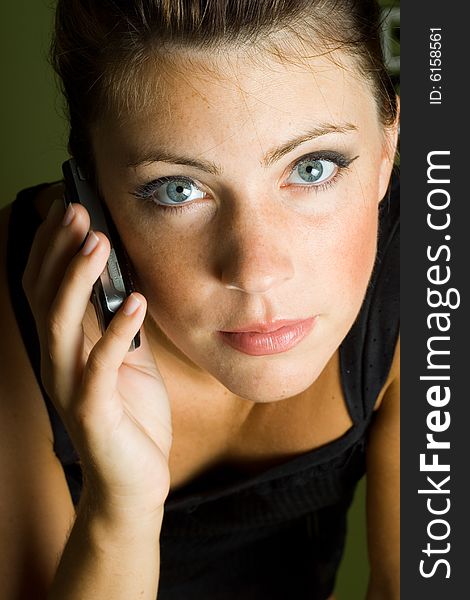 Beautiful woman with telefone looking to the camera. Beautiful woman with telefone looking to the camera